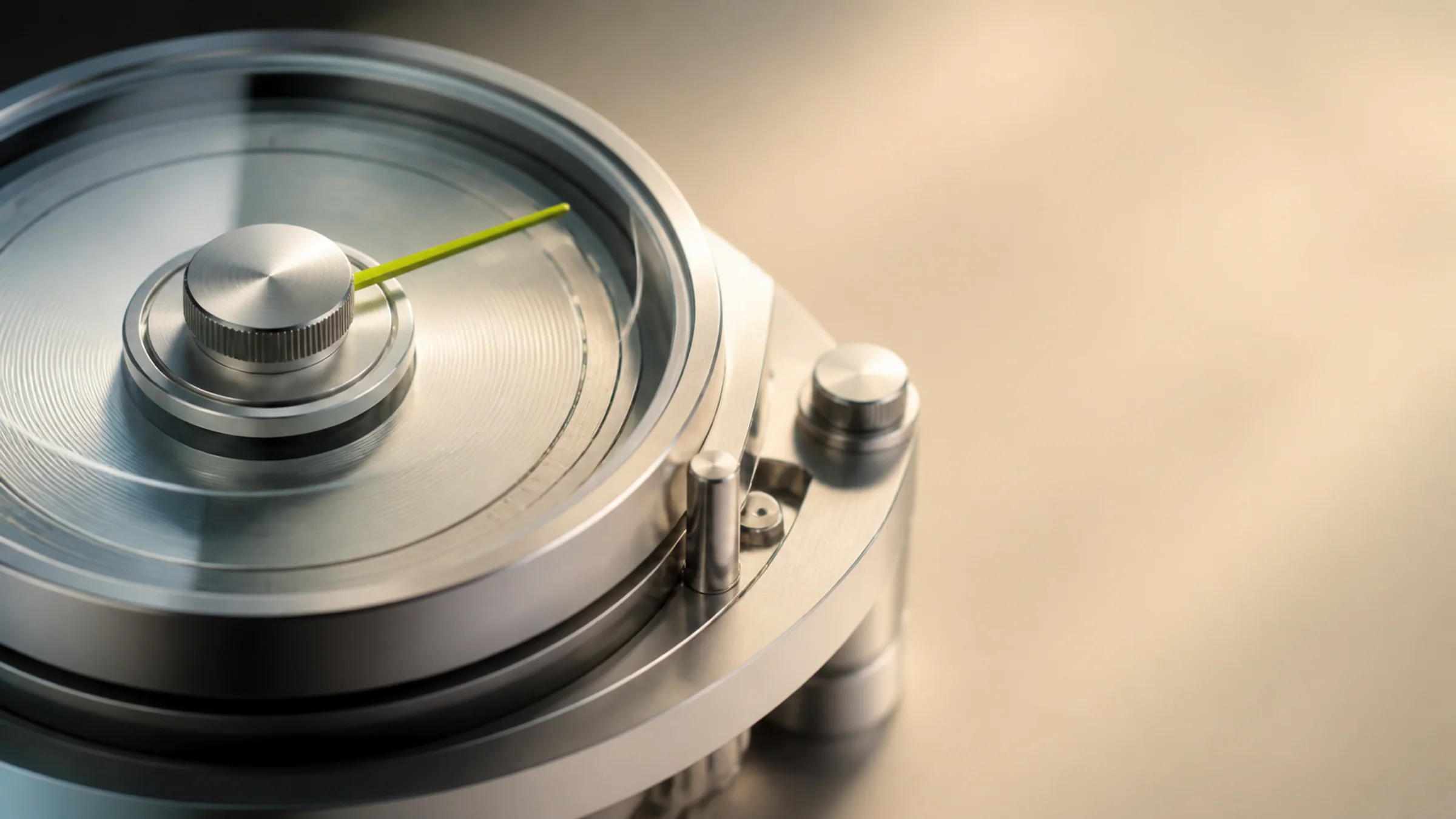 Close-up of a precision analogue instrument dial in dark brushed metal